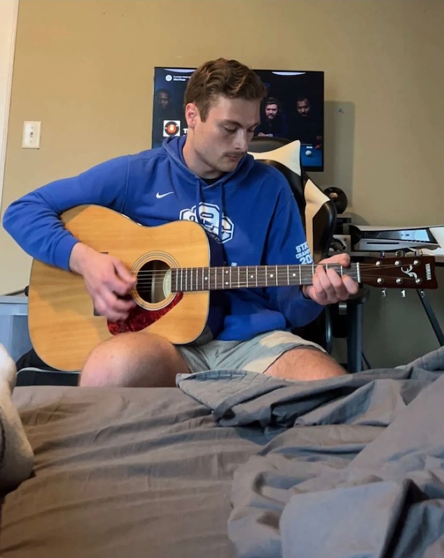 Ethan Lott playing a guitar
