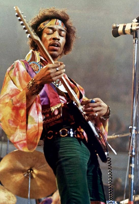 Jimi Hendrix playing guitar onstage