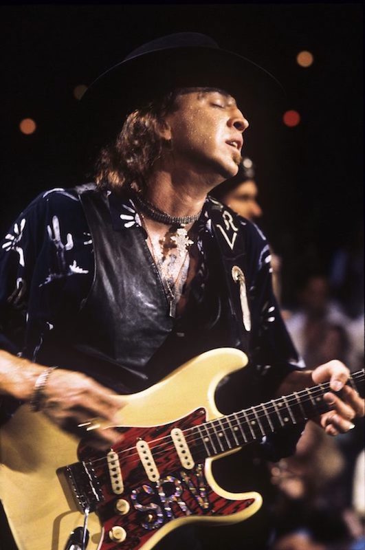 Stevie Ray Vaughan playing guitar onstage